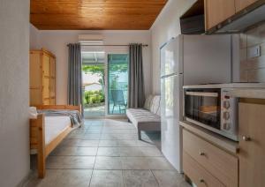 a living room with a couch and a kitchen at Studios Vagelis in Kalamitsi