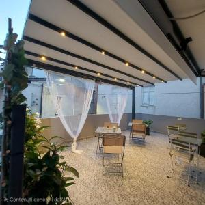 a large room with chairs and tables and curtains at A casa di Adua in Cupello