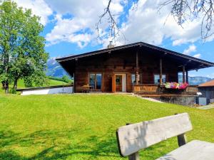 a bench in front of a log cabin at Ferienwohnung Schösserhof in Reith bei Kitzbühel