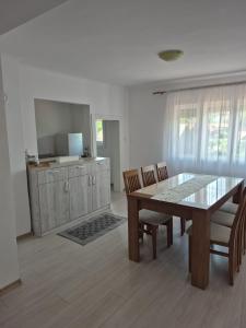a dining room with a table and chairs and a television at Casa De Oaspeti Anna in Sovata