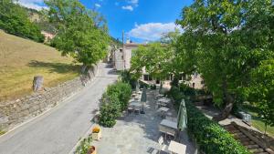 an empty street with benches and a building at Auberge du Coustet in Saint-Léger
