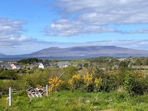 a view of a village with mountains in the distance at Callacoon Cottage in Louisburgh