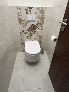 a bathroom with a white toilet in a room at Apartmán pod Rovencom in Nové Mesto nad Váhom