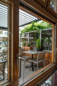 a view of a patio with a table and chairs at Logis Hôtel Restaurant Bellevue Annecy in Annecy