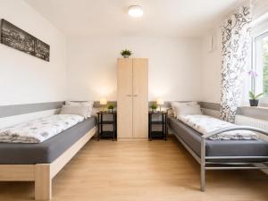 a room with two beds and a window at Ferienhaus Bailey in Laupheim