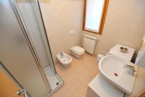 a bathroom with a shower and a toilet and a sink at Eleonora 4A in Temù +4 photos