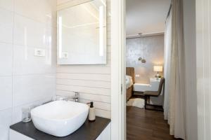 a bathroom with a white sink and a bedroom at Island Breeze Oasis by Belmont Realty in Vela Luka +43 photos