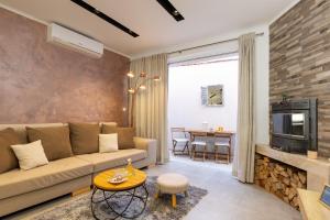 a living room with a couch and a tv at Island Breeze Oasis by Belmont Realty in Vela Luka