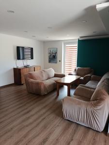 a living room with two couches and a table at Noclegi u Kozickich in Tomaszów Lubelski