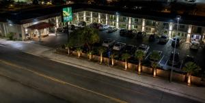 a building with cars parked in a parking lot at night at Quality Inn Parker in Parker +3 photos