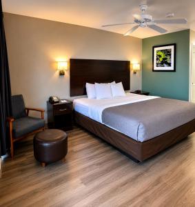 a bedroom with a large bed and a chair at Quality Inn Parker in Parker