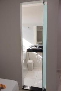a bathroom with a sink and a toilet at Hotel Macapaba in Macapá