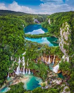 an aerial view of a river in a forest at Plitvice Harmony one - seven person in Smoljanac