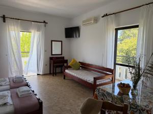 a living room with a couch and a table at Zourpos Studios in Kalyves +18 photos