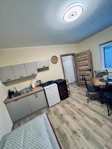 a kitchen and dining room with a table and a kitchen and a room at Ubytování U Špíšků in Jaroslavice
