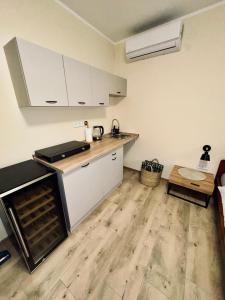 a kitchen with white cabinets and a wooden floor at Ubytování U Špíšků in Jaroslavice +10 photos