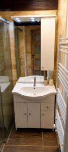 a bathroom with a white sink and a shower at Klidná Chalupa in Bulhary +9 photos