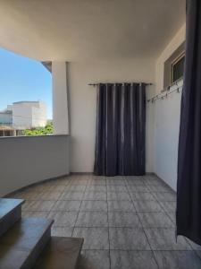 an empty room with a shower curtain and a window at F3 entre nature et calme in Raʼs al Jabal +8 photos