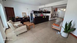 a living room with a couch and a kitchen at Residencial Raiar in Mindelo