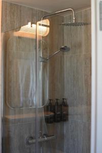 a shower in a bathroom with a glass door at Hotel Local 101 Beaurepaire in Paris
