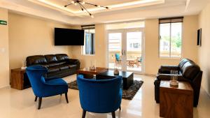 a living room with a couch and a table at Hotel Aljófar in Montemorelos