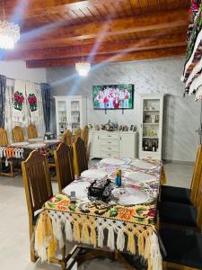 a dining room with a table and chairs at Casa Moroseneasca Breb in Breb