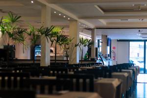 a dining room with tables and chairs and plants at Hotel Macapaba in Macapá +53 photos