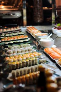 a buffet line with sushi and other food items at Hotel Macapaba in Macapá