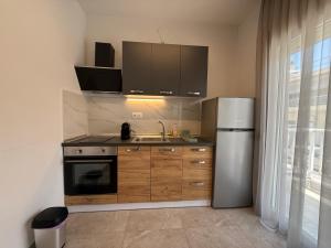 a kitchen with a sink and a refrigerator at K78 Studios B1 in Nea Michaniona