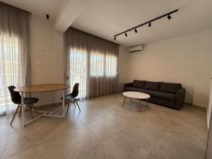 a living room with a couch and a table at K78 Studios B1 in Nea Michaniona