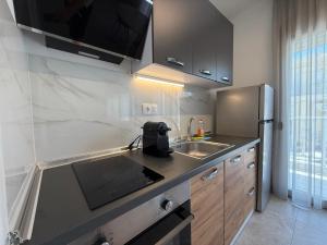 a kitchen with a sink and a refrigerator at K78 Studios B1 in Nea Michaniona