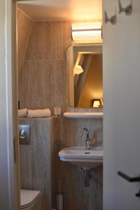 a bathroom with a sink and a mirror at Hotel Local 101 Beaurepaire in Paris