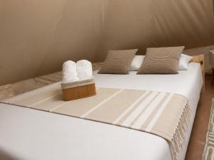 two beds in a tent with towels on them at VaMood in Vama Veche +4 photos