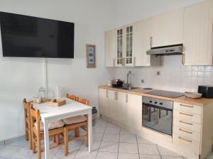 a kitchen with a table and a stove top oven at Brilu in Savona