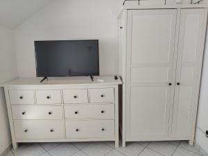 a bedroom with a dresser and a tv on a dresser at Brilu in Savona