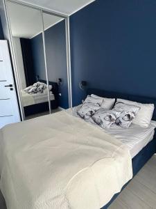 a bedroom with a large white bed with a mirror at Apart Premium Ku Morzu in Sianozety +13 photos