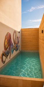 a swimming pool with an octopus painted on the wall at Olivo Mio in La Paz
