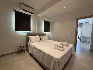 a bedroom with a bed with towels on it at K78 Studios B1 in Nea Michaniona +5 photos