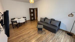 a living room with a couch and a table at Friendly House in Bolesławiec