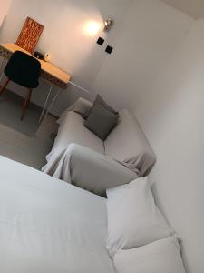 a room with a bed and a couch and a desk at Fortezzino in Rethymno