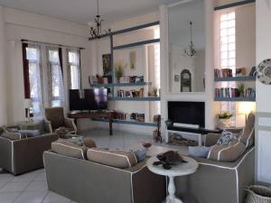 a living room with couches and a table and a television at Clara Resort in Petra