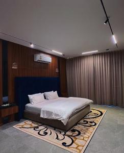 a bedroom with a large bed with a rug at The W Luxury Chalet in Salalah +26 photos