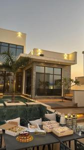 a table with food on it in front of a building at The W Luxury Chalet in Salalah