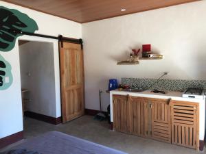 a kitchen with a counter and a wooden door at Thirstybeaver in Playa Santana