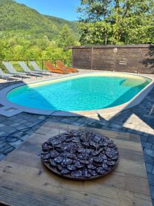 a plate of food on a table next to a swimming pool at Magic Aria Bihac in Bihać