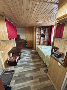 a room with a bed and a wooden ceiling at Смарт-Квартира in Yaremche