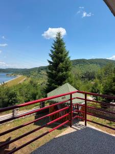a red fence with a view of the water at Villa Tara in Gostivar