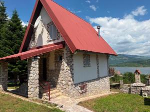 a small stone house with a red roof at Villa Tara in Gostivar