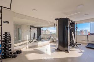 a room with a gym with a view of the city at Studio in Condo. w/ Pool in Downtown MSU0406 in Governador Valadares