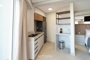 a kitchen with a sink and a stove in a room at Studio in Condo. w/ Pool in Downtown MSU0406 in Governador Valadares